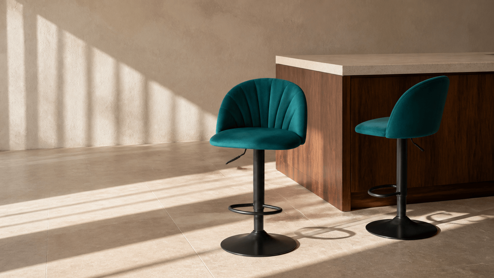 Two emerald ADORN DR259 bar stools beside a walnut island in a sunlit interior